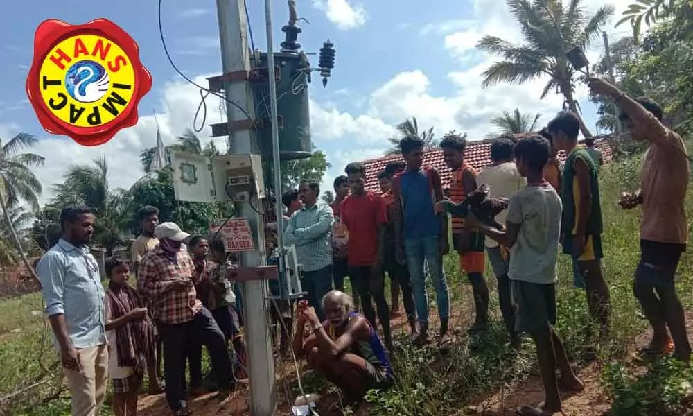 Tribals of Dayarti village in Jeenapadu panchayat of Ananthagiri mandal at the electricity transformer in their village as they get power supply after a prolonged struggle