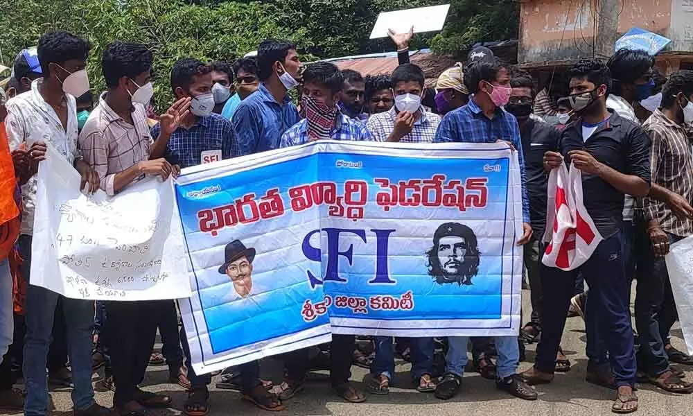 Leaders and members of various students’ unions staging a protest in front of the Collector’s office in Srikakulam on Monday