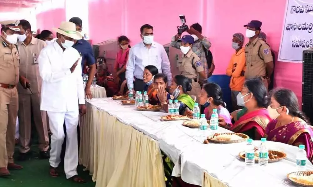 Chief Minister KCR having a word with a villager at the community lunch in his adopted village Vasalamarri on Tuesday