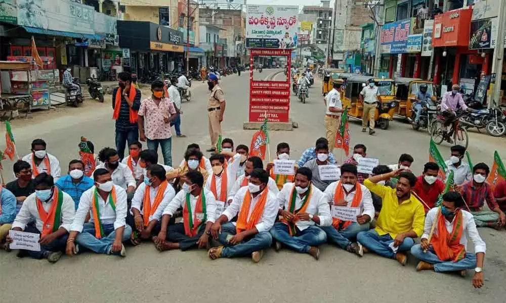 BJYM activists participating in a protest at the Tahsil crossroads at Jagtial town on Tuesday