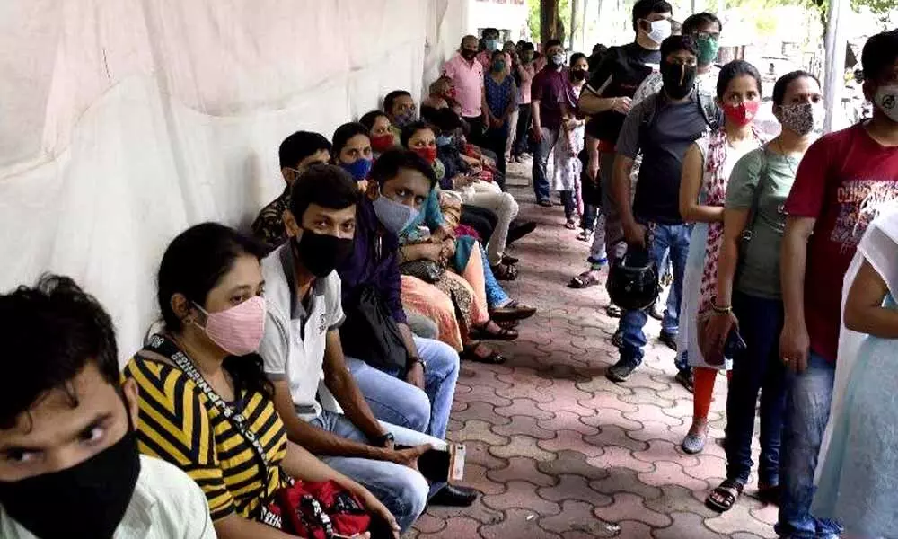 People rest after getting inoculated with a dose of the Covid-19 vaccine