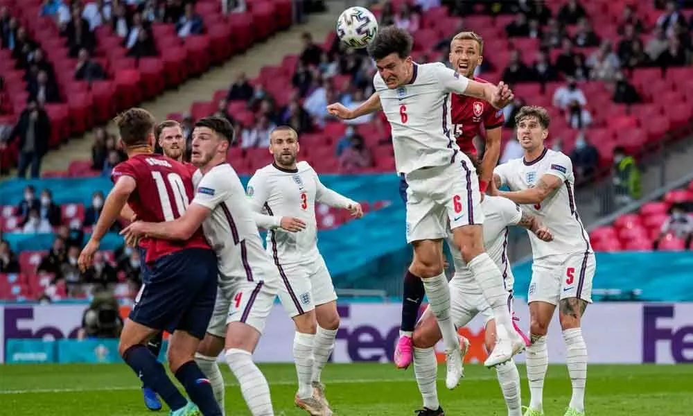 England’s Harry Maguire heads the ball during the Euro 2020 soccer championship group D match between Czech Republic and England at Wembley stadium in London on Tuesday