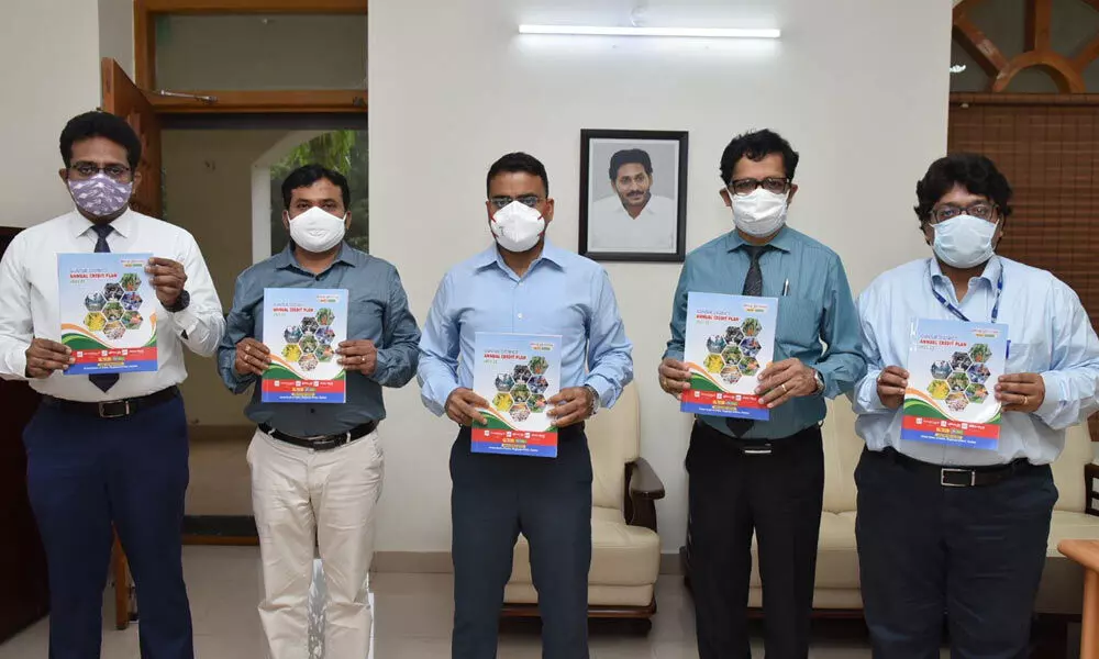 District Collector Vivek Yadav, Lead Bank Manager Ram Babu, bank officials releasing district annual credit plan in Guntur on Wednesday