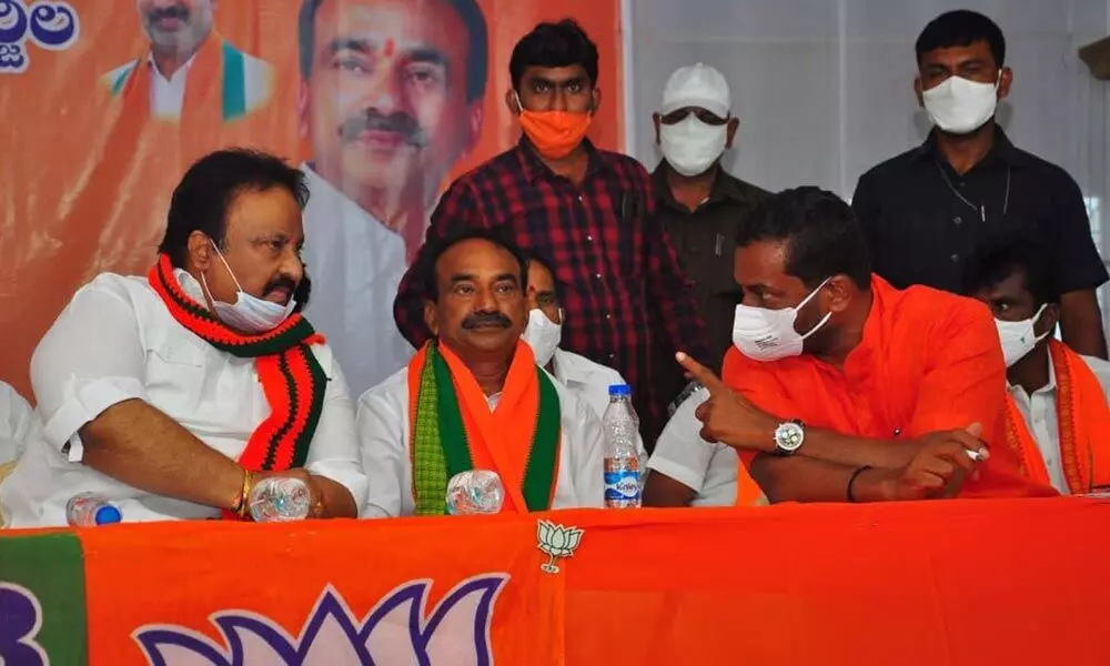 BJP leader M Raghunandan Rao, Etala Rajender and others addressing a meeting, in Huzurabad on Thursday