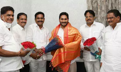 Members of Kshatriya community including Minister Ch Sri Ranganadha Raju and others felicitating Chief Minister Y S Jagan Mohan Reddy at his camp office in Tadepalli on Thursday