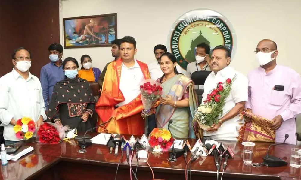 Mayor Dr R Sirisha and Deputy Mayor Mudra Narayana felicitating Municipal Commissioner P S Girisha in Tirupati on Friday
