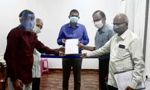 Rate Payers Association president YD Rama Rao and secretary P Raghu Rama Rao submitting a representation to KMC Commissioner Swapnil Dinakar Pundkar in Kakinada