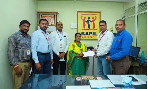 Kapil Chits Yadadri Regional Manager B Yadagiri handing over insurance cheque for Rs 2 lakh to the nominee, Meena, at a programme at Branch-2 in Prakasham Bazar