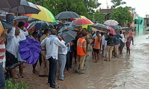 A group of farmers rescued by fire fighting personnel at Nandavaram in Kurnool district