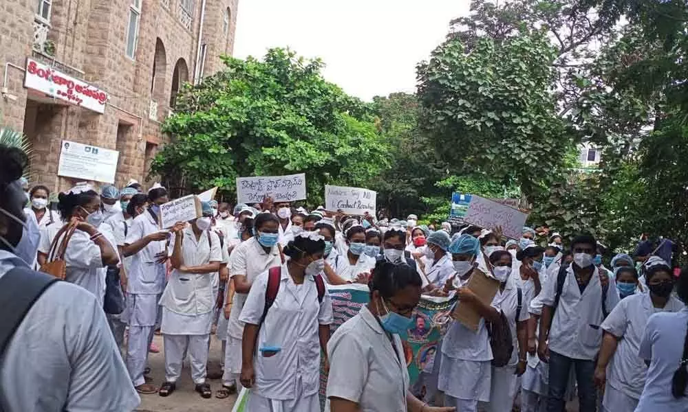 Staff nurses staging a protest at King George Hospital in Visakhapatnam on Monday. The nurses demand equal pay for equal work.