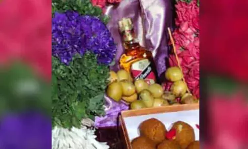Priests offering prayers to liquor bottle at the Chowdeshwari Devi Ammavari temple in Nandavaram