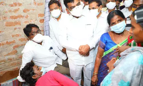 Minister Ajay Kumar and MP Nama Nageswara Rao interacting with Mariyamma’s family members at her house in Komatlagudem village on Monday