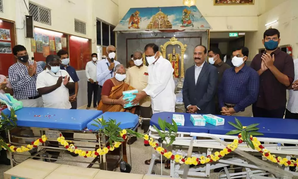 MLA Bhumana Karunakar Reddy handing over stretchers, facemasks and gloves to SVIMS Director Dr Vengamma in Tirupati on Tuesday