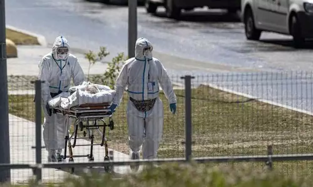 Medical workers carry a patient suspected of having Covid-19 on a stretcher at a hospital in Moscow, Russia (AP Photo)