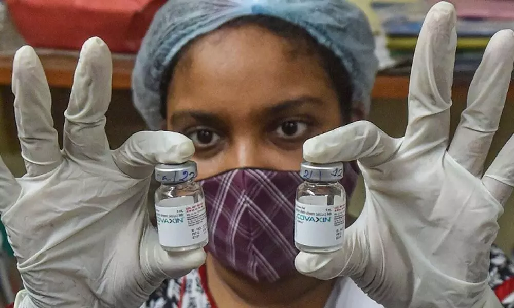 A health worker shows the vials fo Covaxin dose, at a vaccination centre in Kolkata. (Photo | PTI)