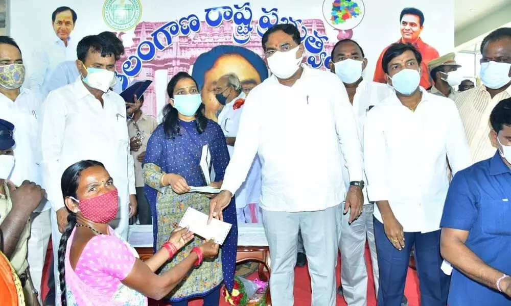 Panchayat Raj Minister Errabelli Dayakar Rao giving away the cheque to a Kalyana Laxmi beneficiary in Palakurthy of Jangaon district on Wednesday