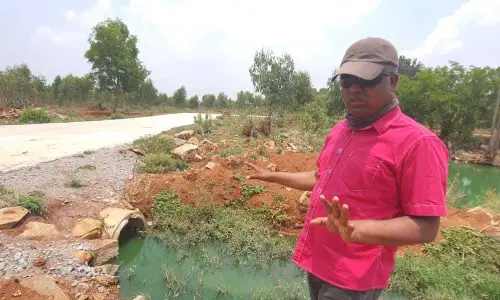 Captain Santhosh Kumar inspecting the lake in Anekal