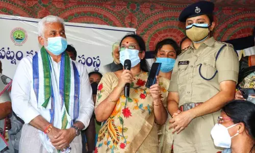 Rajya Sabha member V Vijayasai Reddy and Chairperson of Andhra Pradesh Women’s Commission Vasireddy Padma educating women on the use of Disha app in Visakhapatnam on Wednesday