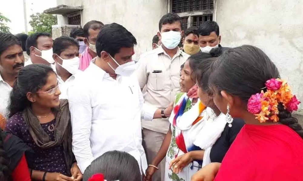 R&B Minister Prashant Reddy interacting with girls during Palle Pragathi programme in Devunipally village, Bhimgal Mandal on Friday
