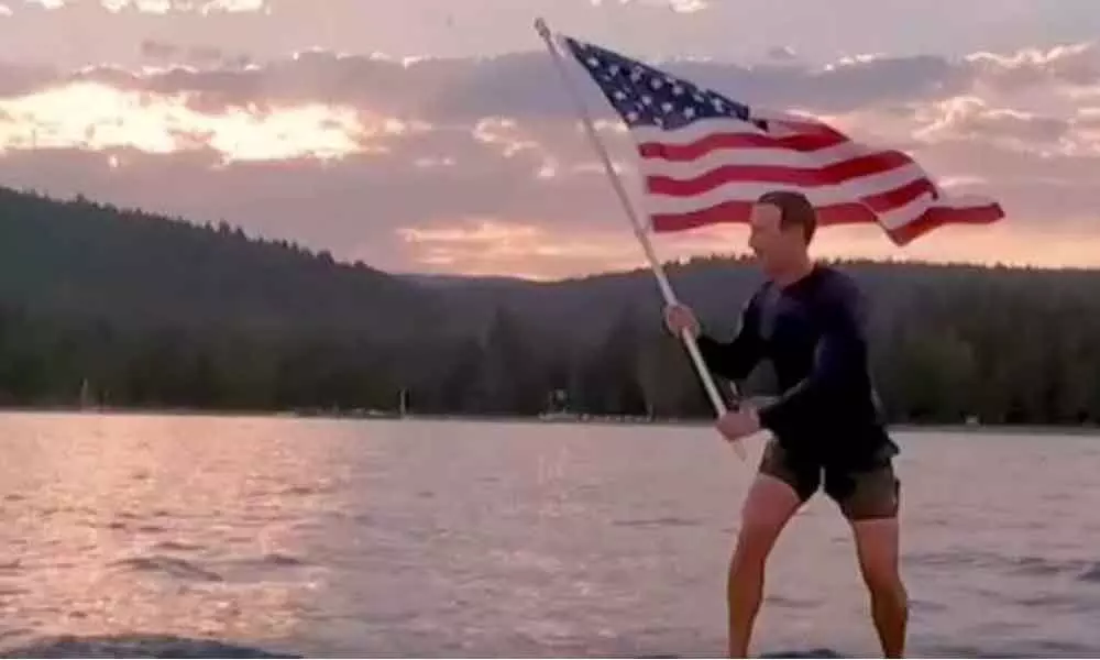 Mark Zuckerberg celebrates Independence Day by waving the American flag on a surfboard