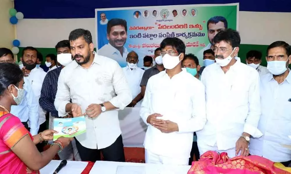 Minister for Water Resources Dr. P Anil Kumar Yadav distributing land pattas to the poor in 15th division in Nellore on Monday