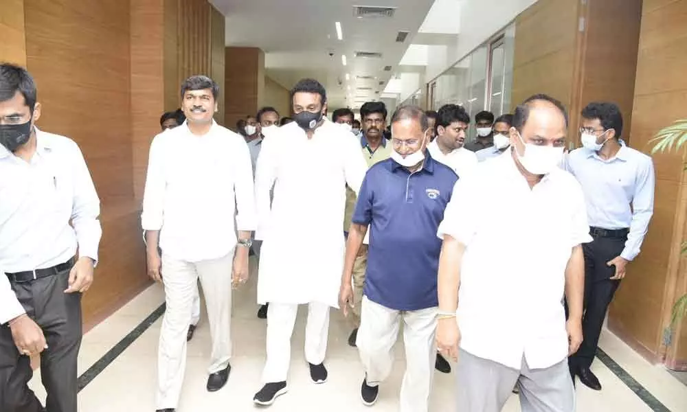 Industries and IT Minister Mekapati Goutham Reddy visiting Indus Genes Expressions Limited at Koduru village in Chilamattur mandal on Monday. R&B Minister M Sankara Narayana and others are also seen.