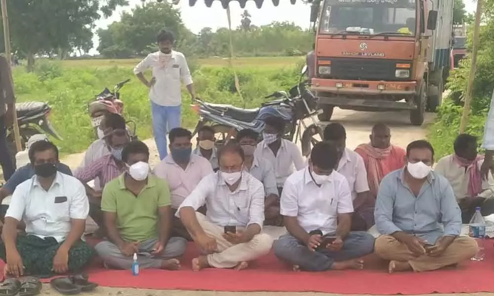 Farmers staging a protest over dumping waste in their fields, in Kamanchikal village on Monday