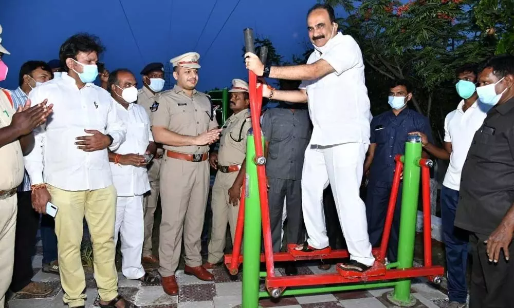 Minister Balineni Srinivasa Reddy trying his hand on the machines at the open-air gym at Police DTC in Ongole on Wednesday