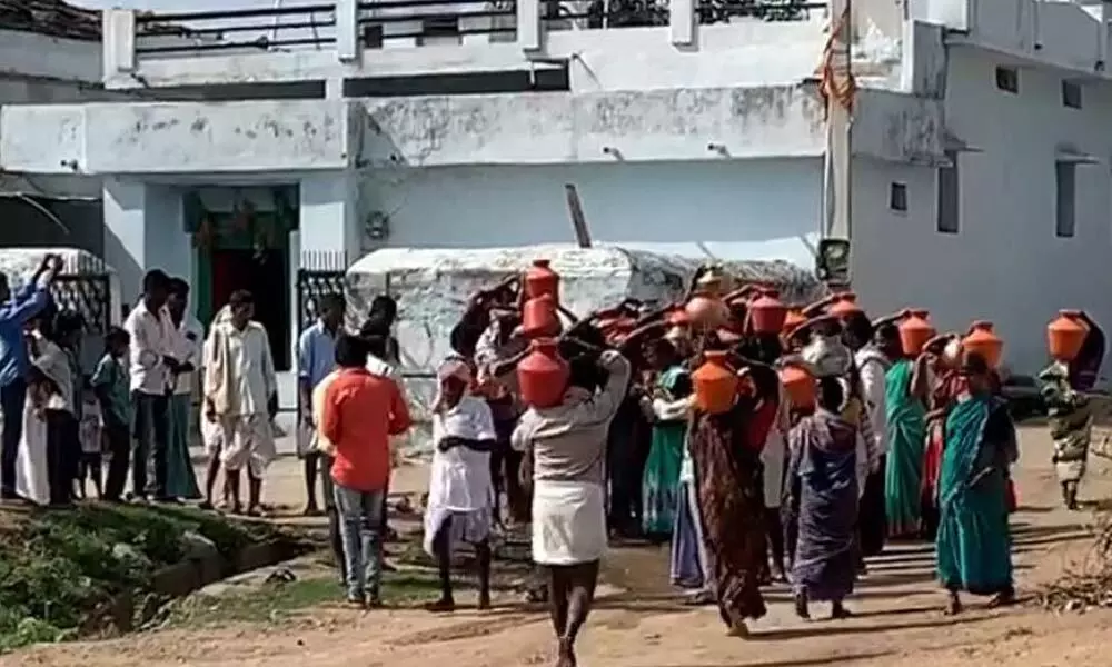 Villagers carrying water for performing Jalabhishekam to Shiva Lingam in Regadi Mailaram village on Wednesday