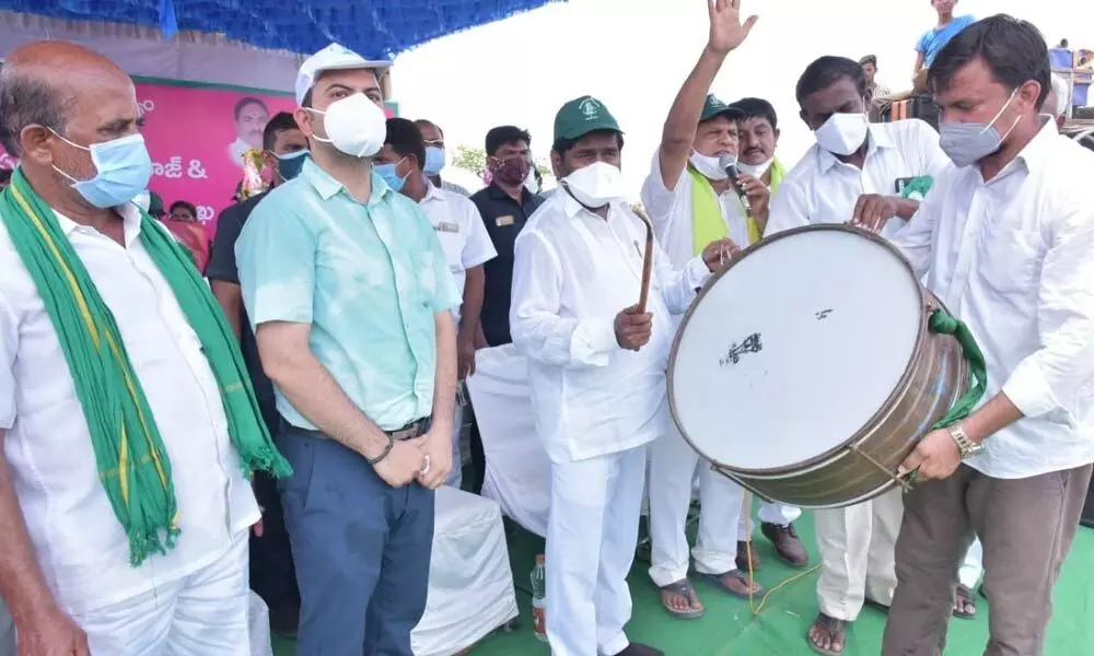 Energy Minister G Jagadish Reddy beating a drum during the plantation of 5,000 saplings as part of the mega Haritha Haram programme at Nenavath Thanda on Wednesday