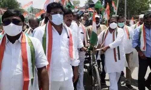 APCC chief Dr Sake Sailajanath pulling a rickshaw with the motor bike on it as part of protest against hike of fuel prices in Chimakurthy on Friday