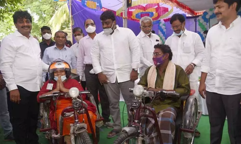 MP Dr M Gurumoorthy distributing tricycles to disabled at a programme in Tirupati on Saturday