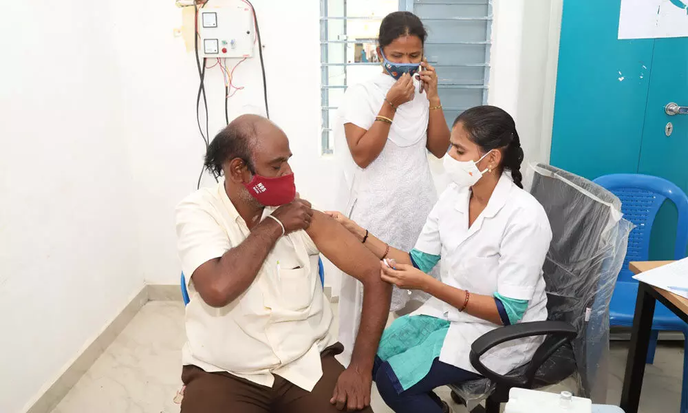 A nurse administering vaccine to a man at Sankaran Journalist Colony in Tirupati