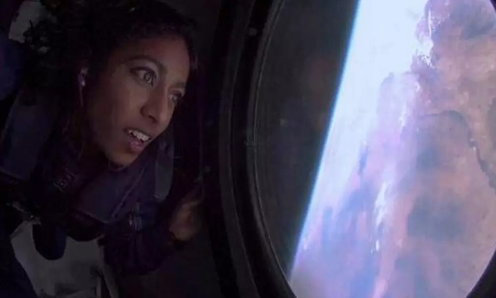 Sirisha Bandla looks out from the window at Earth in zero gravity on board Virgin Galactics passenger rocket plane VSS Unity after reaching the edge of space on Sunday