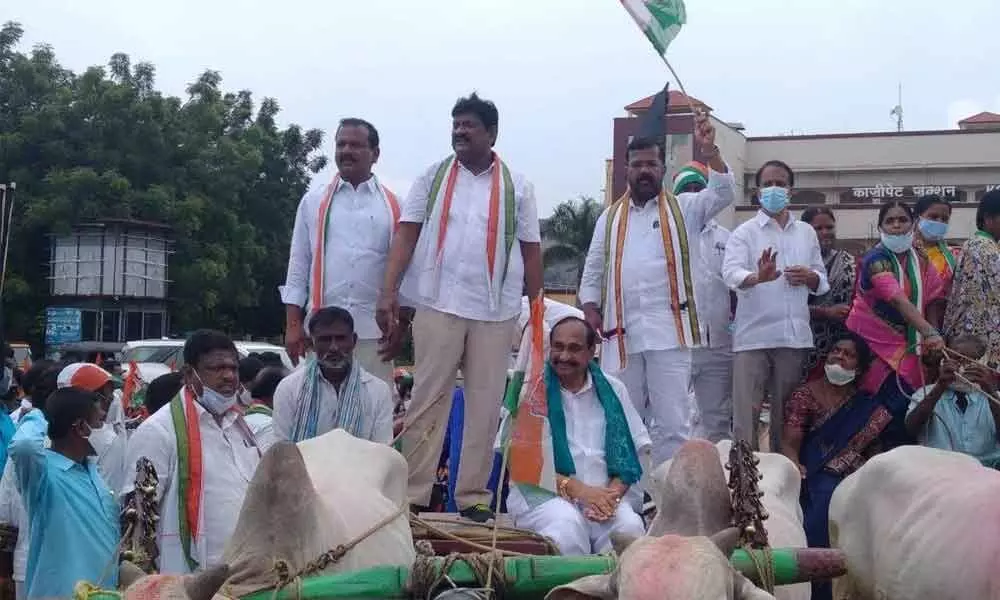 Congress workers during the protest against rising fuel price in erstwhile Warangal District on Monday
