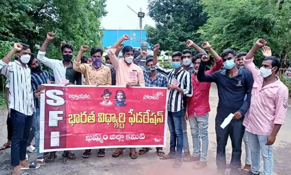 SFI leaders staging a protest in front of Government Degree College in Khammam on Monday