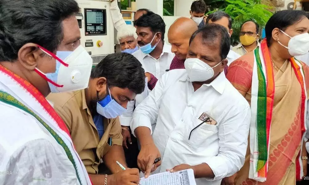 State Congress president Dr Sake Sailajanath collecting signatures of people against fuel price hike in Vijayawada on Tuesday