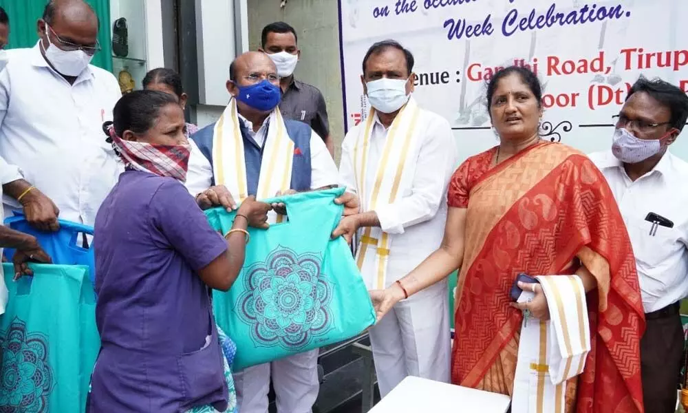 MLA Bhumana Karunakar Reddy distributing essentials to sanitary workers at a function organised by Dr YSR Praja Prasthanam Seva Trust at Tirumala on Tuesday