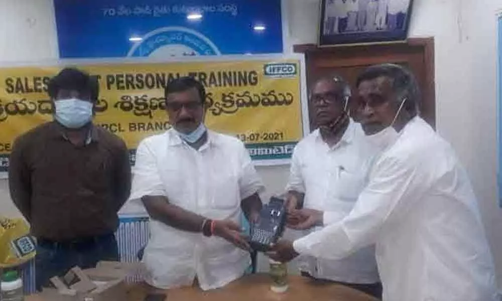 Ch Rajeshwara Rao along with Managing Director P Shankar Reddy distributing PSO machine to fertilizer dealers on Tuesday