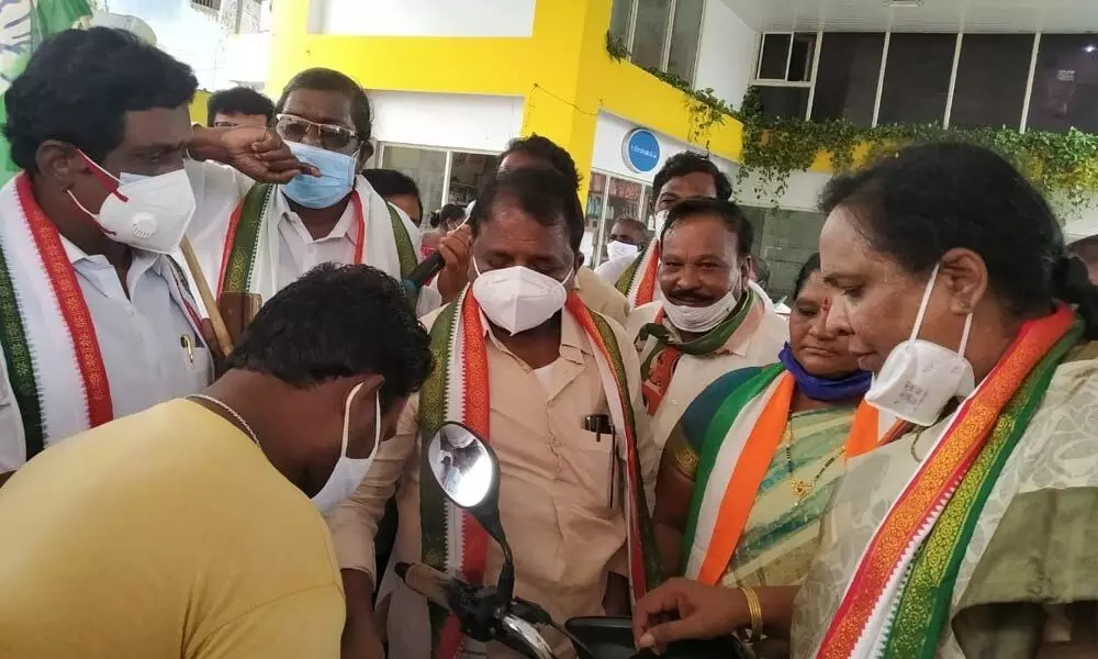 PCC president Dr Sake Sailajanath participating in a signature campaign against fuel price hike in Machilipatnam on Wednesday