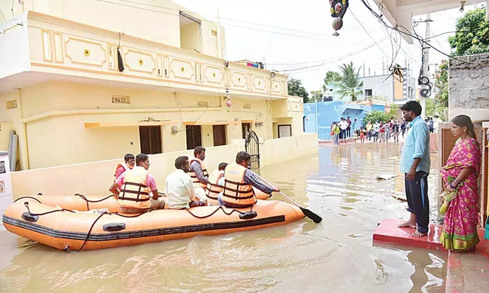 Flood waters gushed into the houses in Bandlaguda, following incessant rain and consequently giving sleepless night to the dwellers. 	Photo Adula Krishna