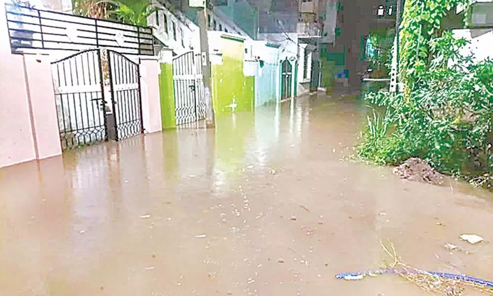 Normal life took a beating as dwellers in Malkajgiri were forced to wade through thick sheets of rainwater to reach their homes