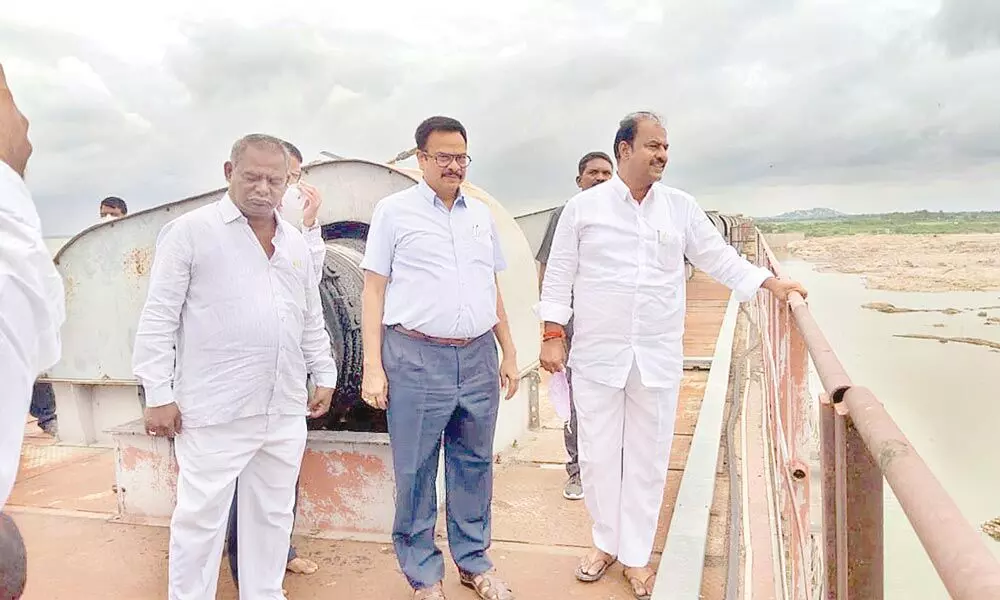 MLA Bandla Krishna Mohan looking over Jurala project after launching repair works of crust gates of the project on Thursday