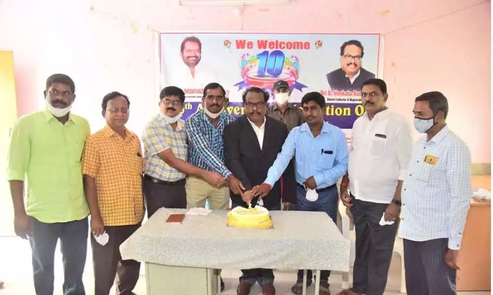 District Collector S Venkat Rao cutting a cake on the 10th anniversary of The Hans India, in Mahabubnagar on Friday