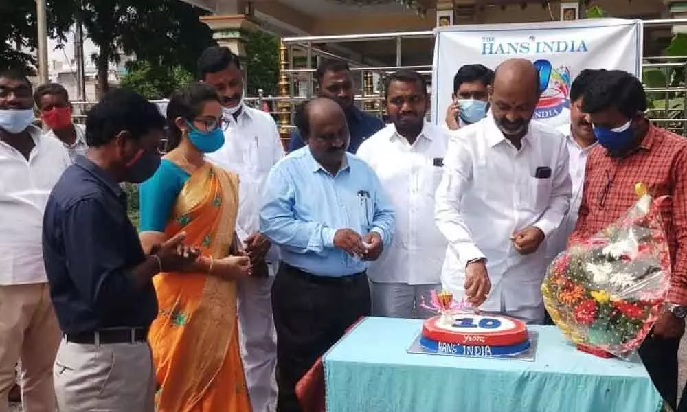 BJP State president Bandi Sanjay Kumar cuts a cake marking 10th anniversary celebrations of The Hans India in Karimnagar on Friday