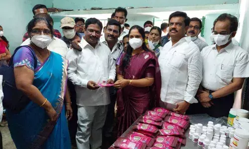 Mayor Dr Sirisha distributing medicines to people at a free medical camp held at Annarao Circle in Tirupati on Friday.