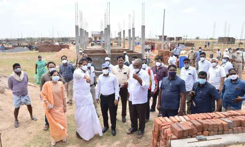 Deputy Speaker Kona Raghupati and district Collector Vivek Yadav interacting with housing beneficiaries in Bapatla on Friday