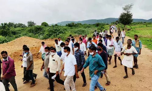 Former Minister Jupally Krishna Rao along with tribals on way to talks with forest officials in Amrabad on Friday