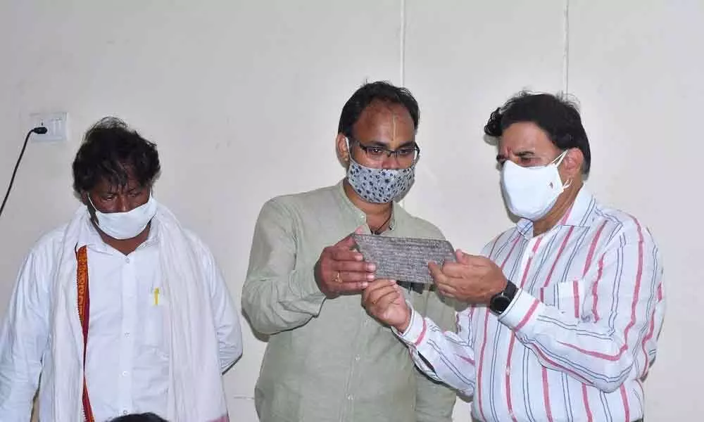 Srisailam temple Executive Officer K S Rama Rao observing the E-stamping process of copper inscriptions in Srisailam on Saturday