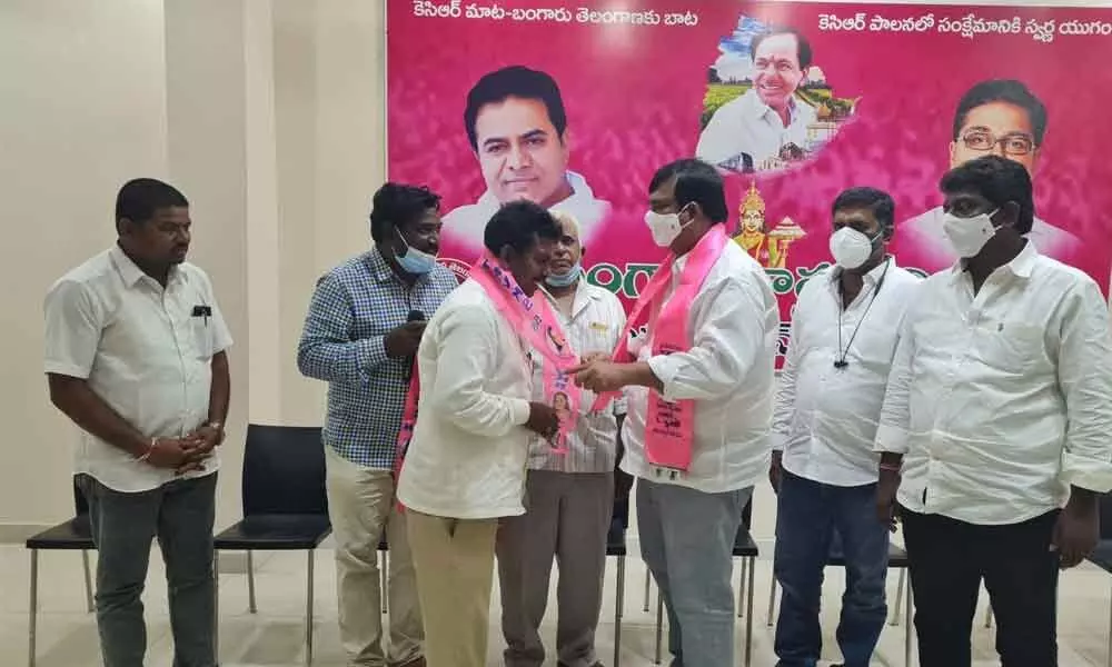 TRSKS district honorary President RJC Krishna welcoming several electricity department employees in to the party in Khammam on Saturday